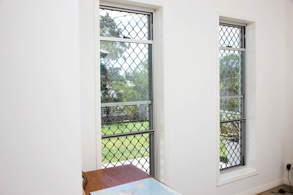 Welded Diamond grille security window screen on double hung windows